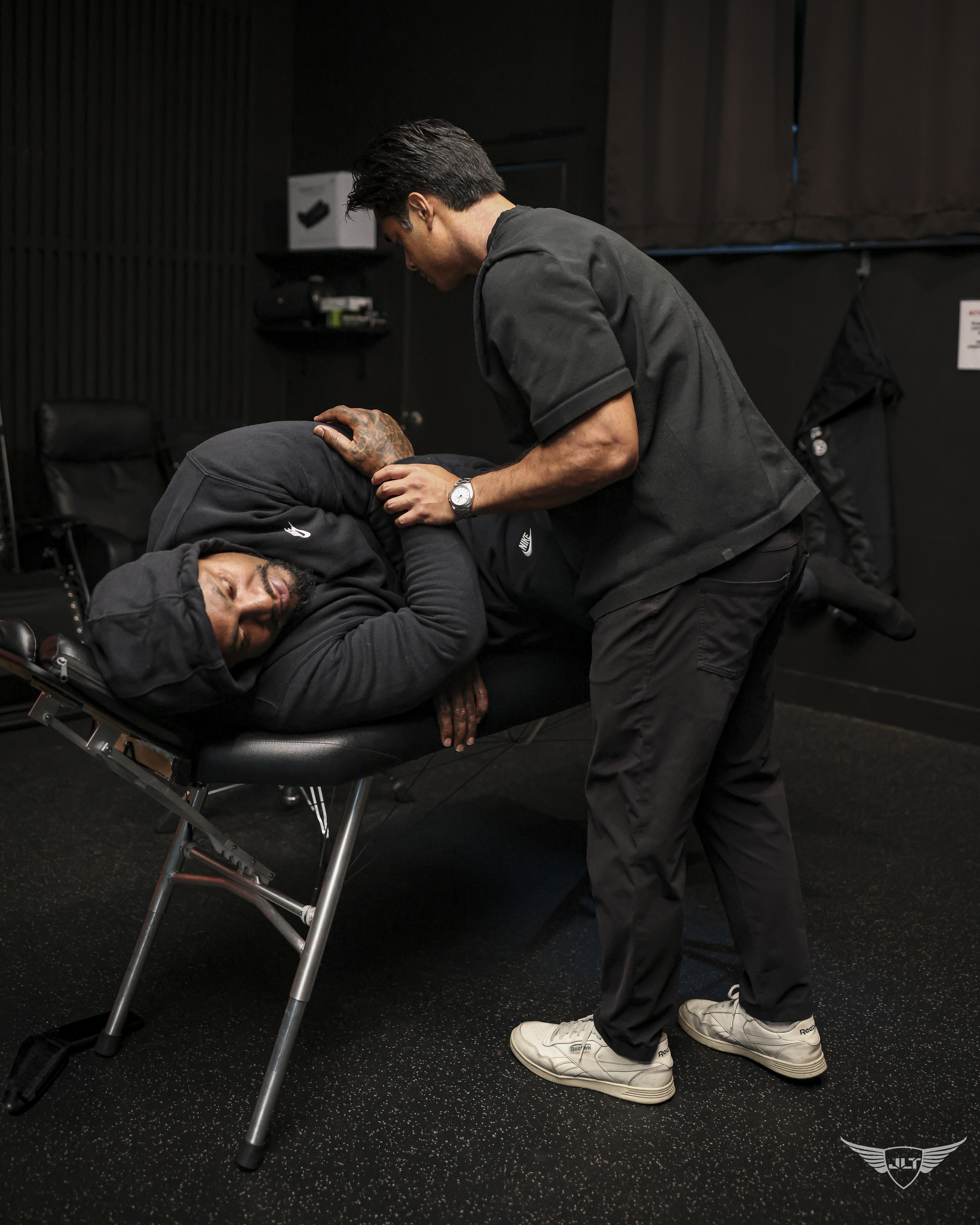 Dr. Tim providing hands-on recovery care on a treatment table