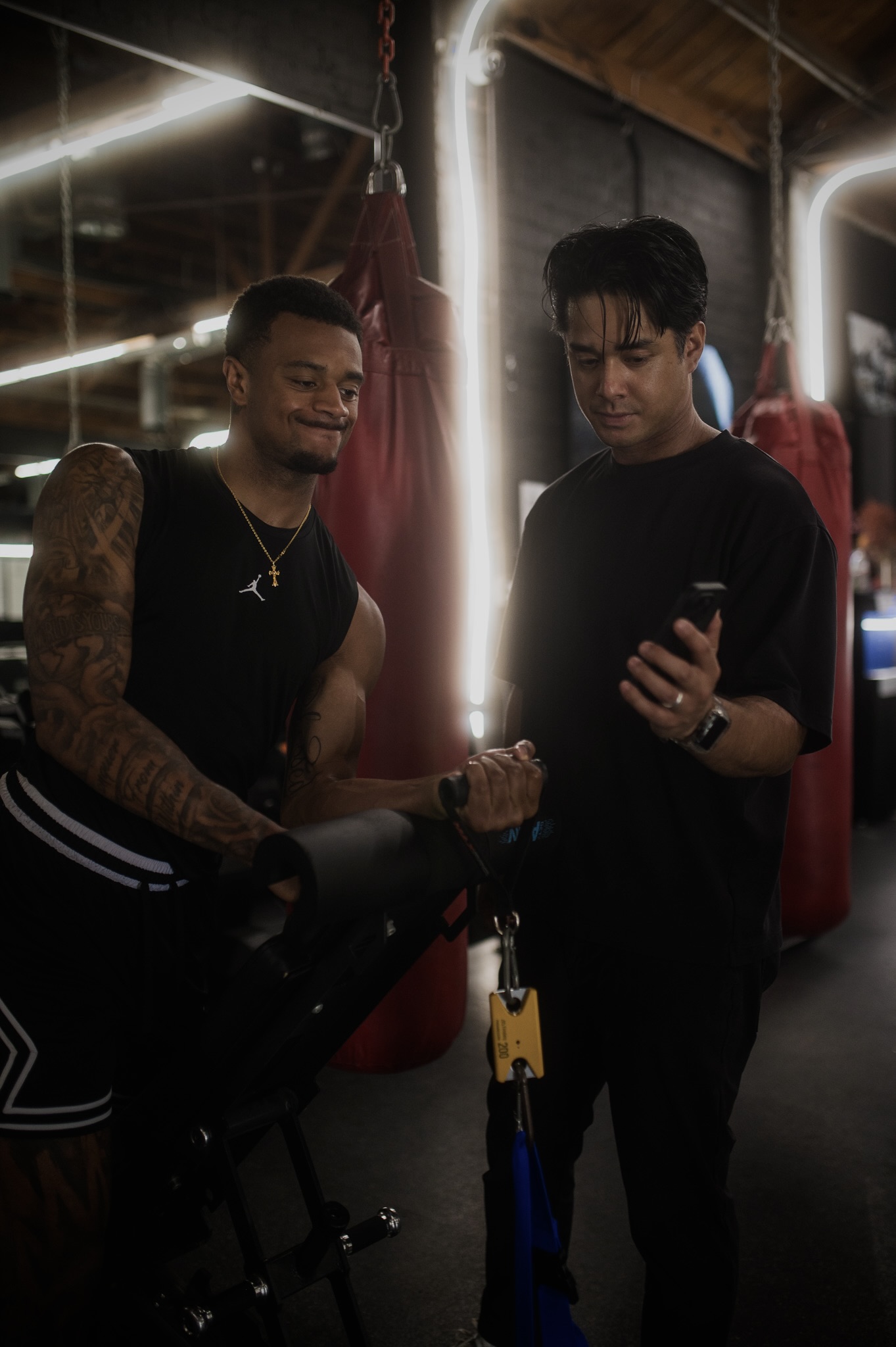 Dr. Tim reviewing a session with an athlete in the gym