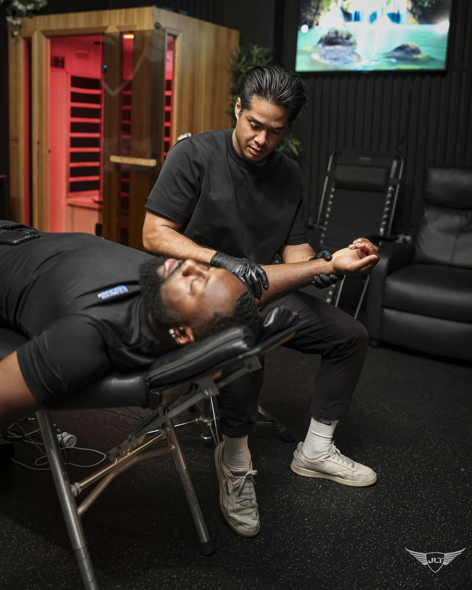 Dr. Tim providing hands-on shoulder care to an athlete